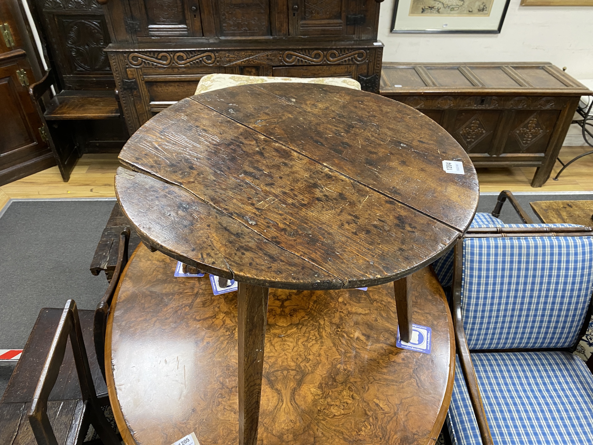 An early 19th century oak and pine cricket table, diameter 64cm, height 63cm